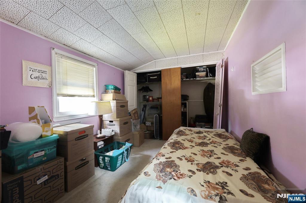 136 Elm Street Cresskill, NJ 07626 - Photo 11 of 24 a bedroom with a bed and wooden floor