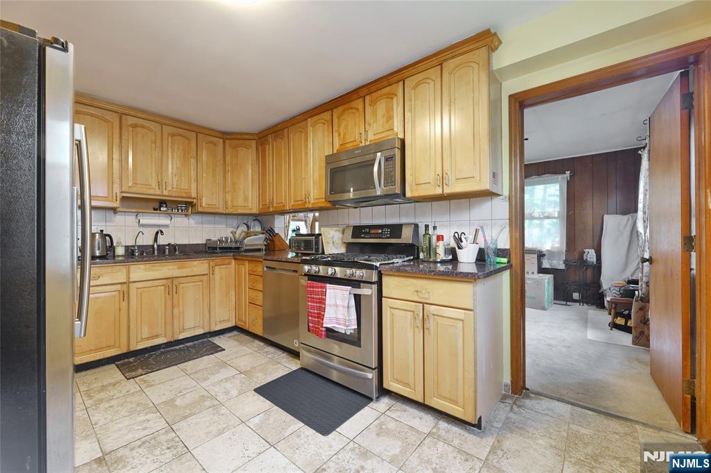 136 Elm Street Cresskill, NJ 07626 - Photo 6 of 24 a kitchen with stainless steel appliances granite countertop a stove a sink and a refrigerator