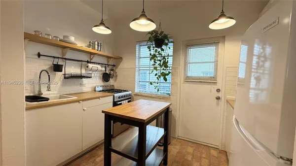 a kitchen with stainless steel appliances a refrigerator and a sink