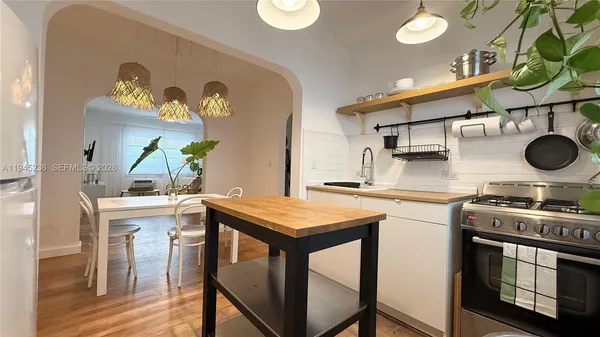 a kitchen with stainless steel appliances granite countertop a stove and a sink