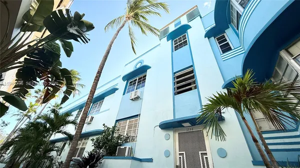 a view of balcony with a potted plant and palm trees