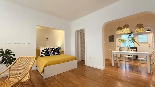 a bedroom with furniture and wooden floor