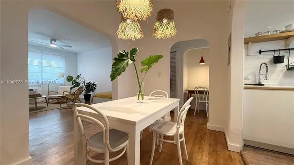 a view of a dining room with furniture and wooden floor