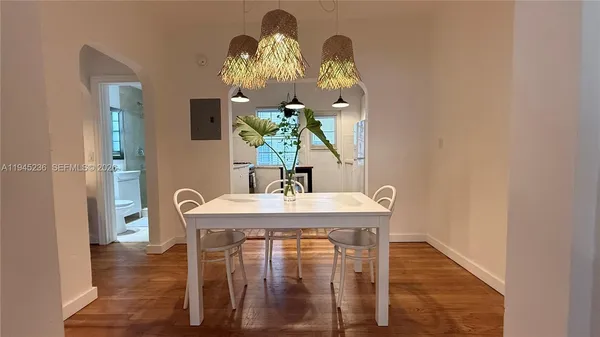 a view of a dining room with furniture and wooden floor