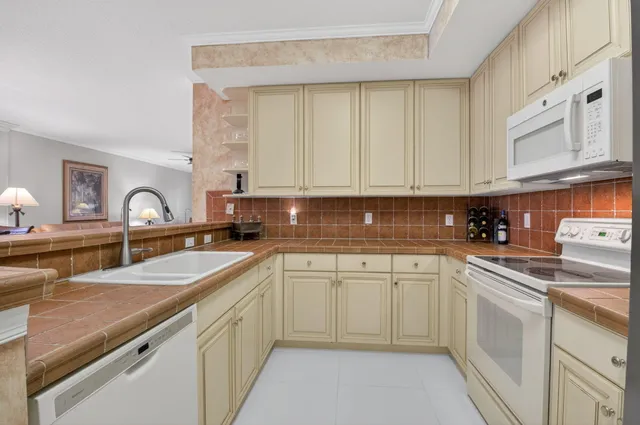 a kitchen with a sink stove and cabinets