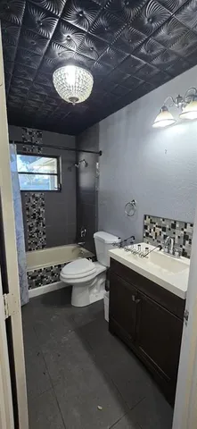 a bathroom with a sink a toilet and mirror