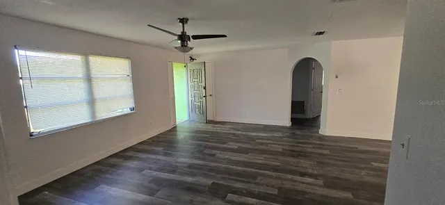 wooden floor in an empty room with a window