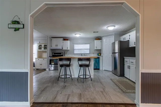 a kitchen with a stove a sink and a refrigerator
