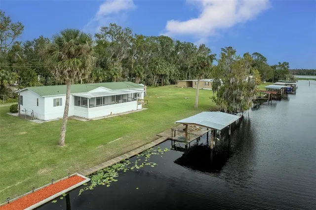 a view of a house with backyard porch and sitting area