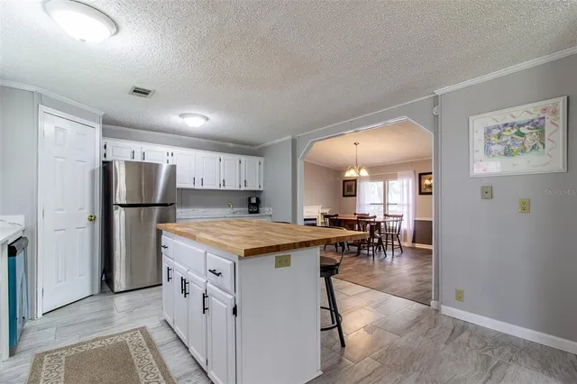 a living room with stainless steel appliances kitchen island granite countertop furniture and a kitchen view