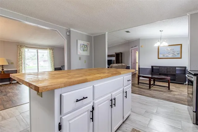 a living room with stainless steel appliances kitchen island granite countertop furniture and a kitchen view