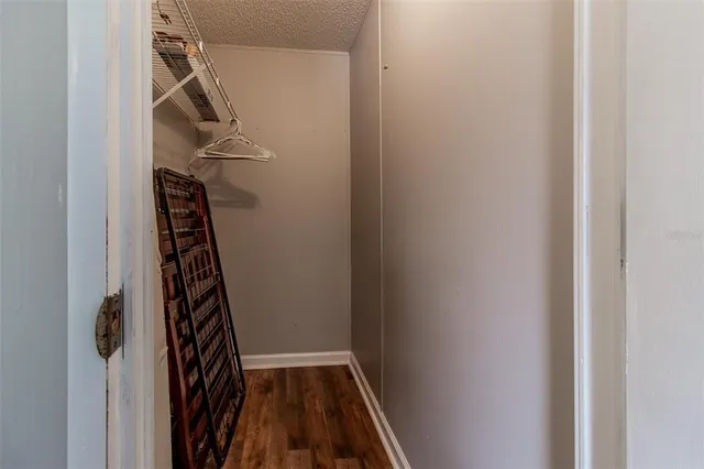 a view of a room with wooden floor and a window