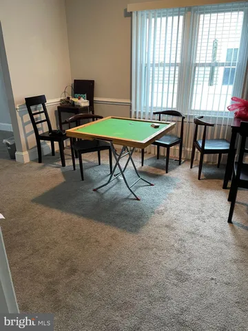 a kitchen with granite countertop a sink cabinets wooden floor and stainless steel appliances