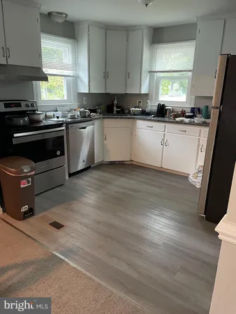 a kitchen with stainless steel appliances granite countertop a refrigerator sink and stove