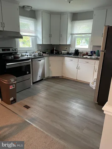 a kitchen with stainless steel appliances granite countertop a refrigerator sink and stove