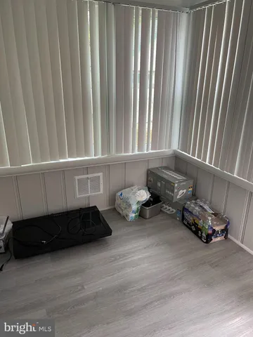 a view of white cabinets and a wooden floor