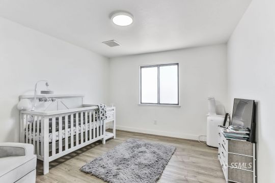 832 Walker Lane Ridgecrest, CA 93555 - Photo 16 of 23 a bedroom with furniture and wooden floor