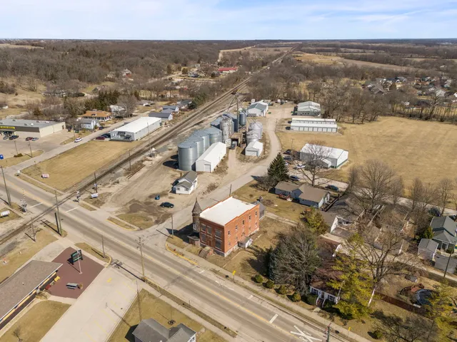 an aerial view of multiple houses with yard