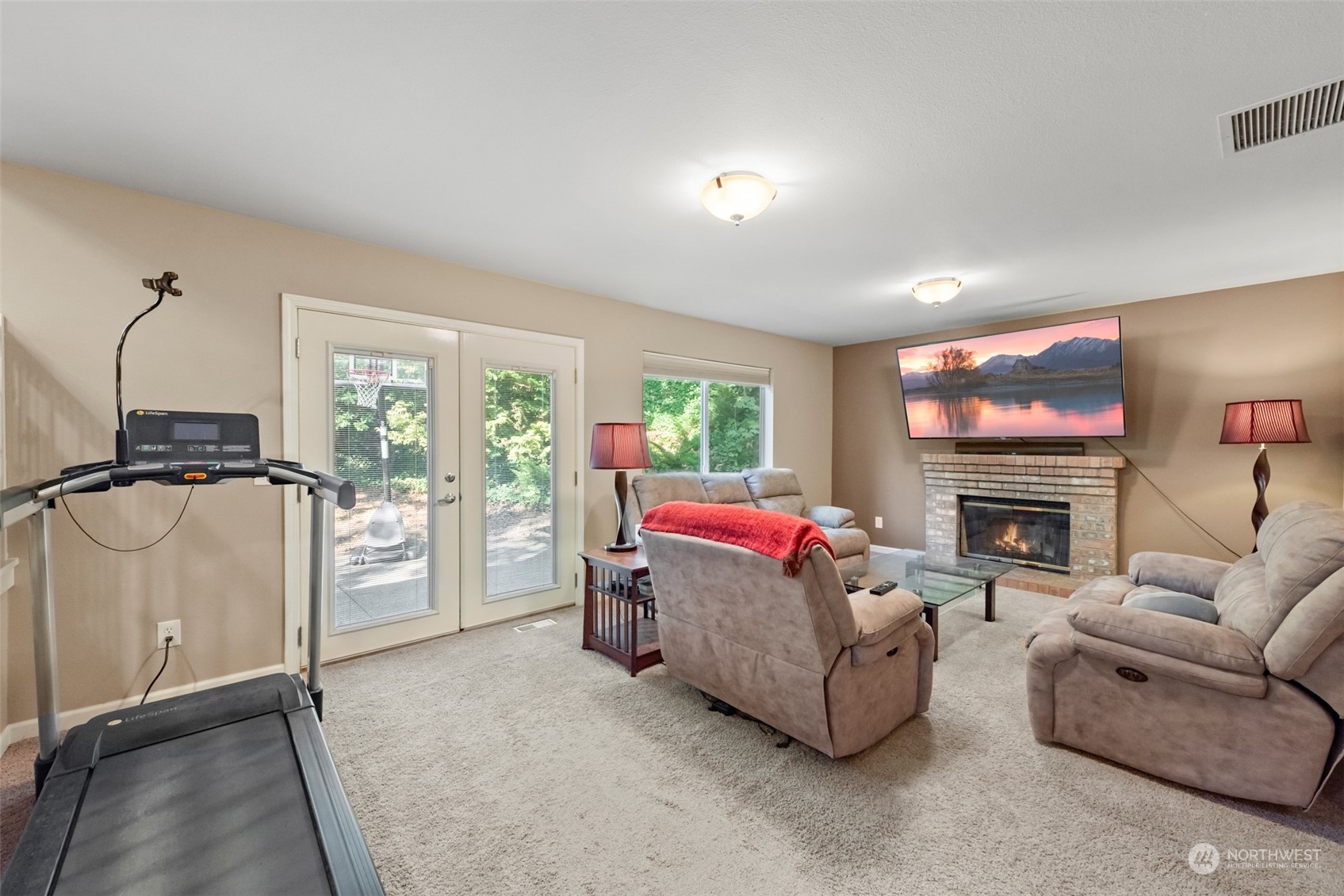 750 South 55th Street Renton, WA 98055 - Photo 4 of 31 a living room with furniture a fireplace and a flat screen tv
