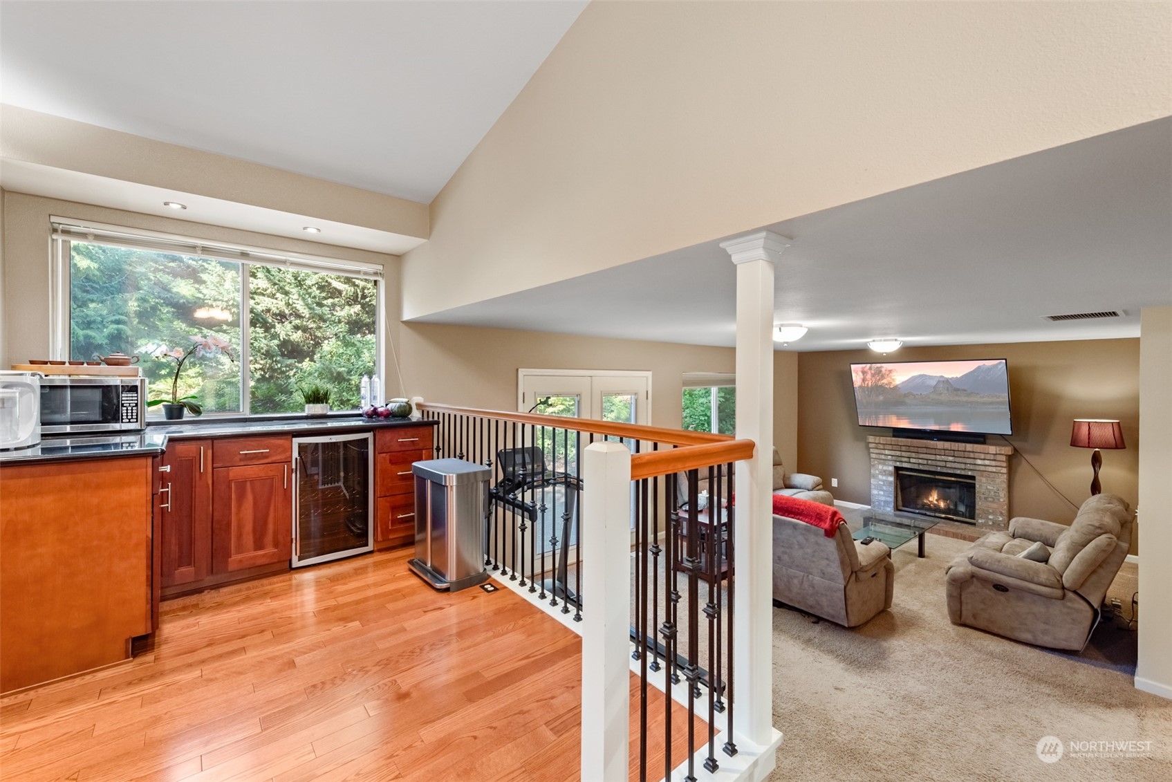 750 South 55th Street Renton, WA 98055 - Photo 6 of 31 a living room with furniture a flat screen tv and a floor to ceiling window