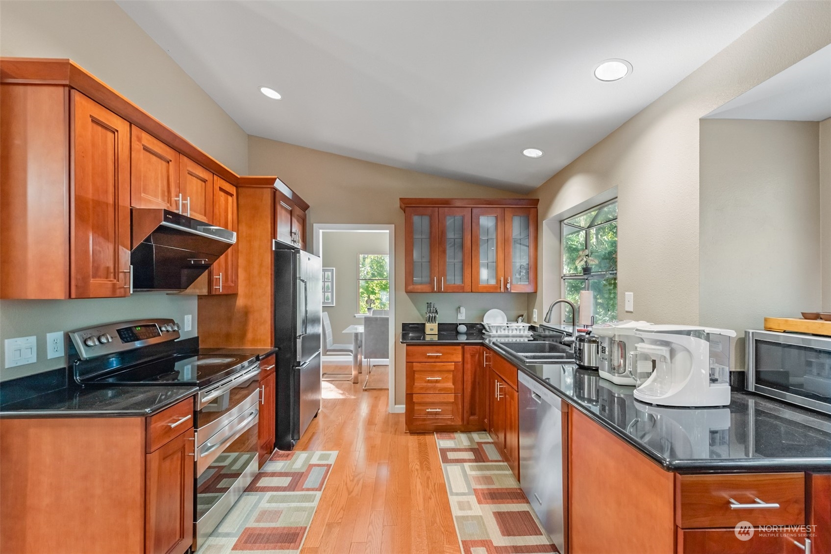 750 South 55th Street Renton, WA 98055 - Photo 9 of 31 a large kitchen with kitchen island granite countertop a sink a counter top space and stainless steel appliances