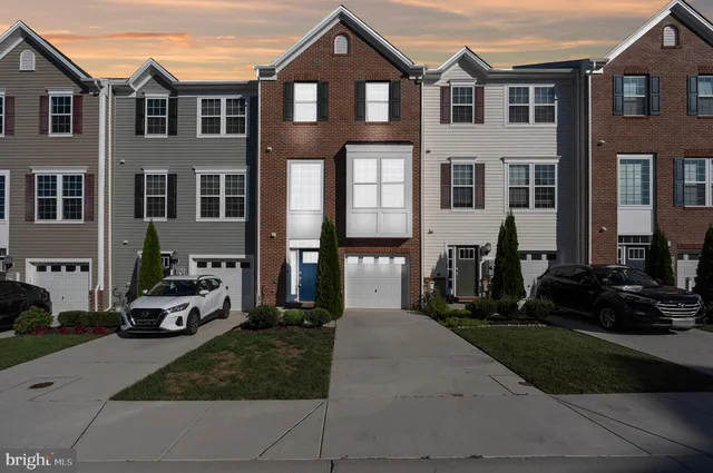 a front view of a residential apartment building with a yard