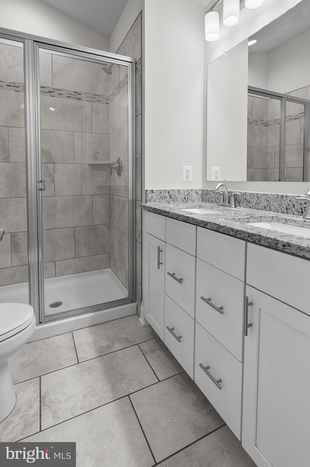 534 Calvert Way Aberdeen, MD 21001 - Photo 14 of 26 a bathroom with a granite countertop sink a mirror and a shower