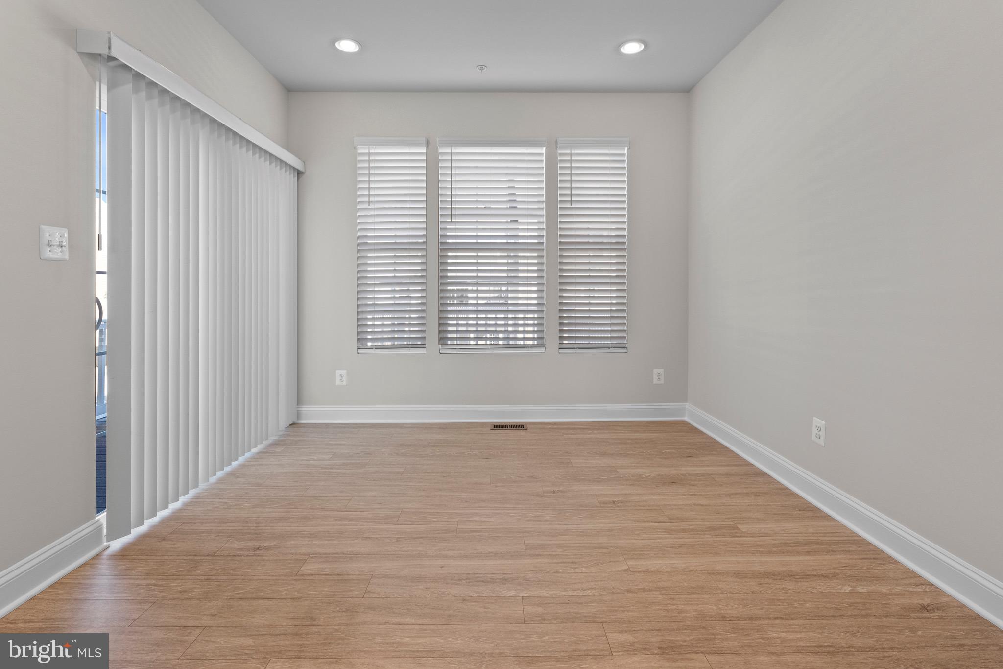 534 Calvert Way Aberdeen, MD 21001 - Photo 7 of 26 a view of an empty room with wooden floor and a window