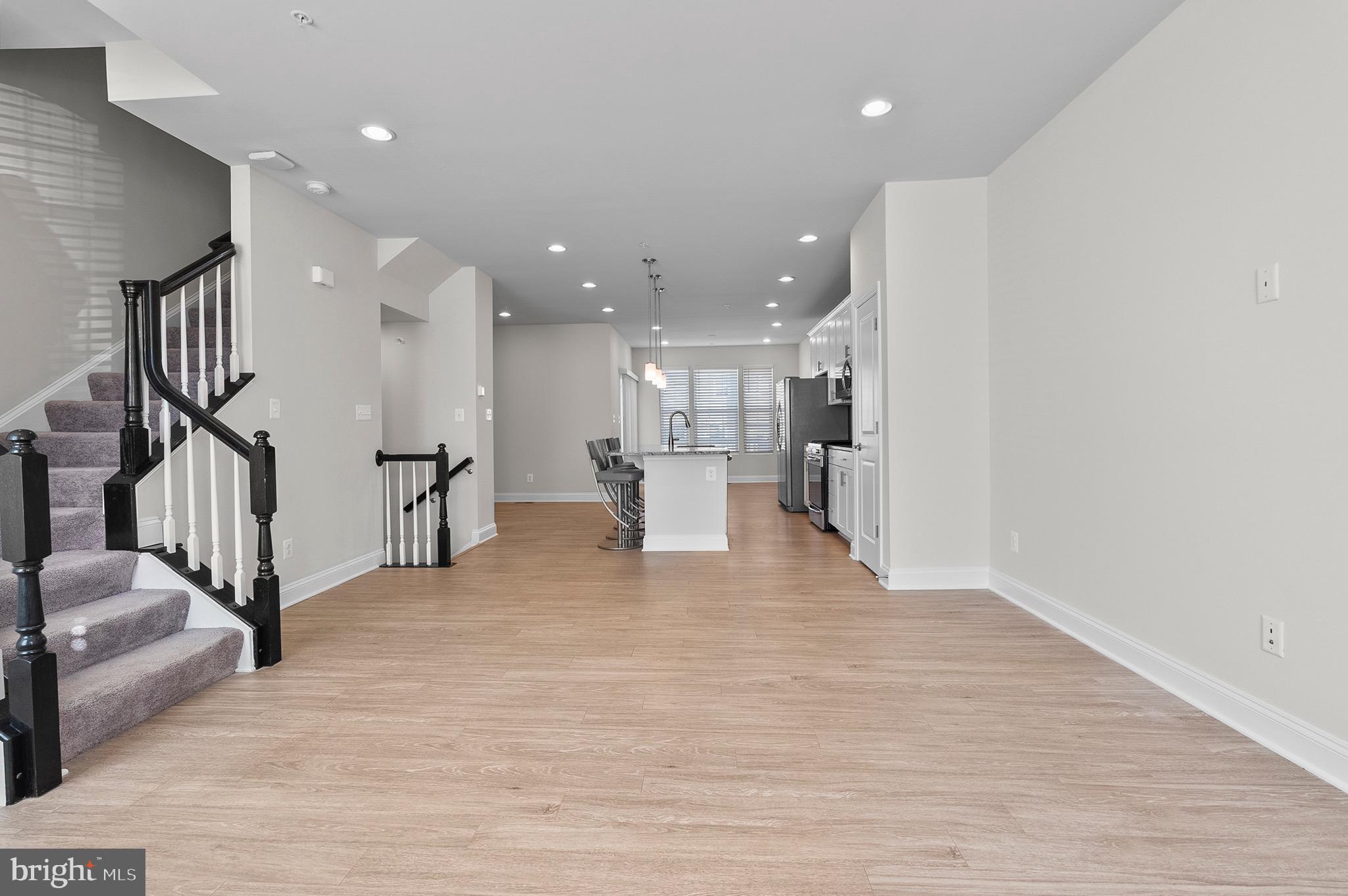 534 Calvert Way Aberdeen, MD 21001 - Photo 9 of 26 a view of a living room and kitchen with a wooden floor
