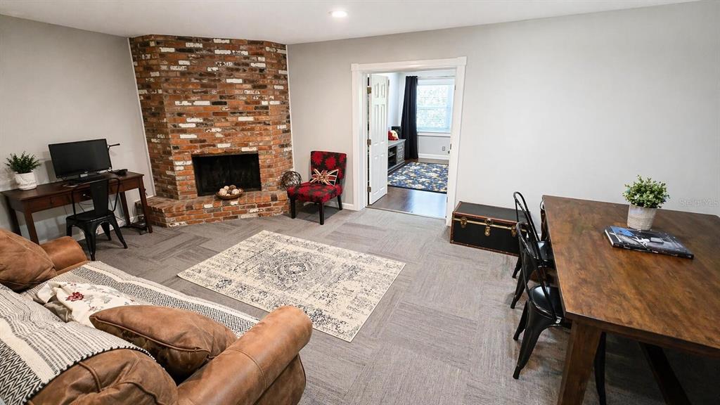 2313 Southeast 7th Street Ocala, FL 34471 - Photo 8 of 54 a living room with furniture a fireplace and a flat screen tv