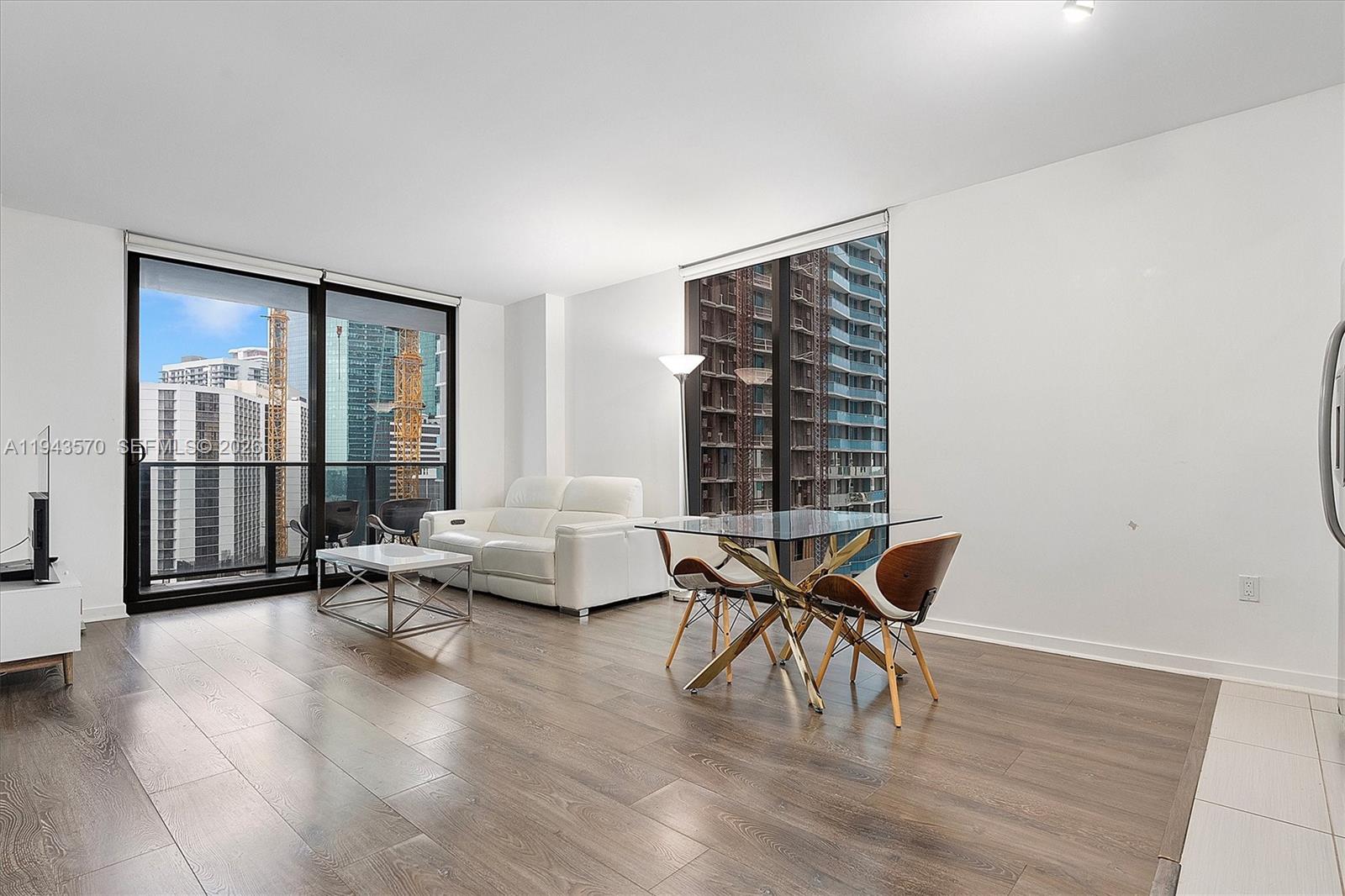 31 Southeast 6th Street, Unit 2008 Miami, FL 33131 - Photo 2 of 21 a living room with furniture and a window