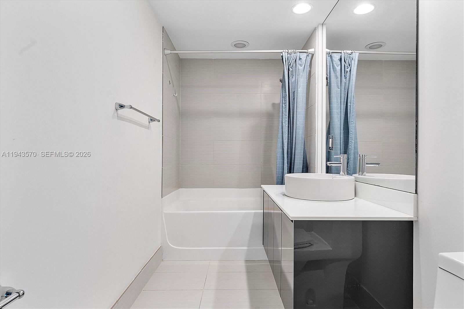 31 Southeast 6th Street, Unit 2008 Miami, FL 33131 - Photo 9 of 21 a bathroom with a sink and a mirror