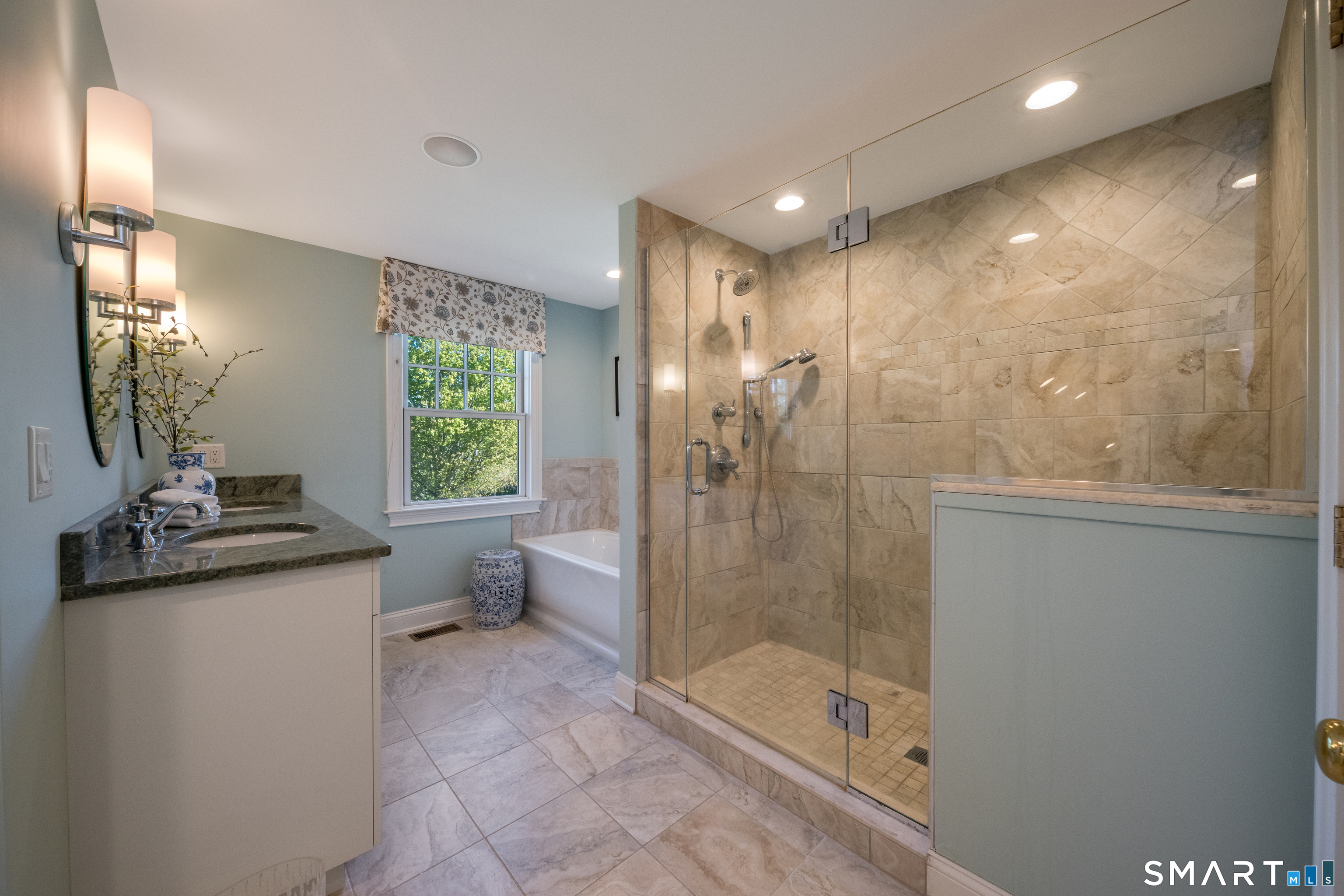 28 Walden Hill Road Guilford, CT 06437 - Photo 19 of 35 a bathroom with a shower sink and mirror