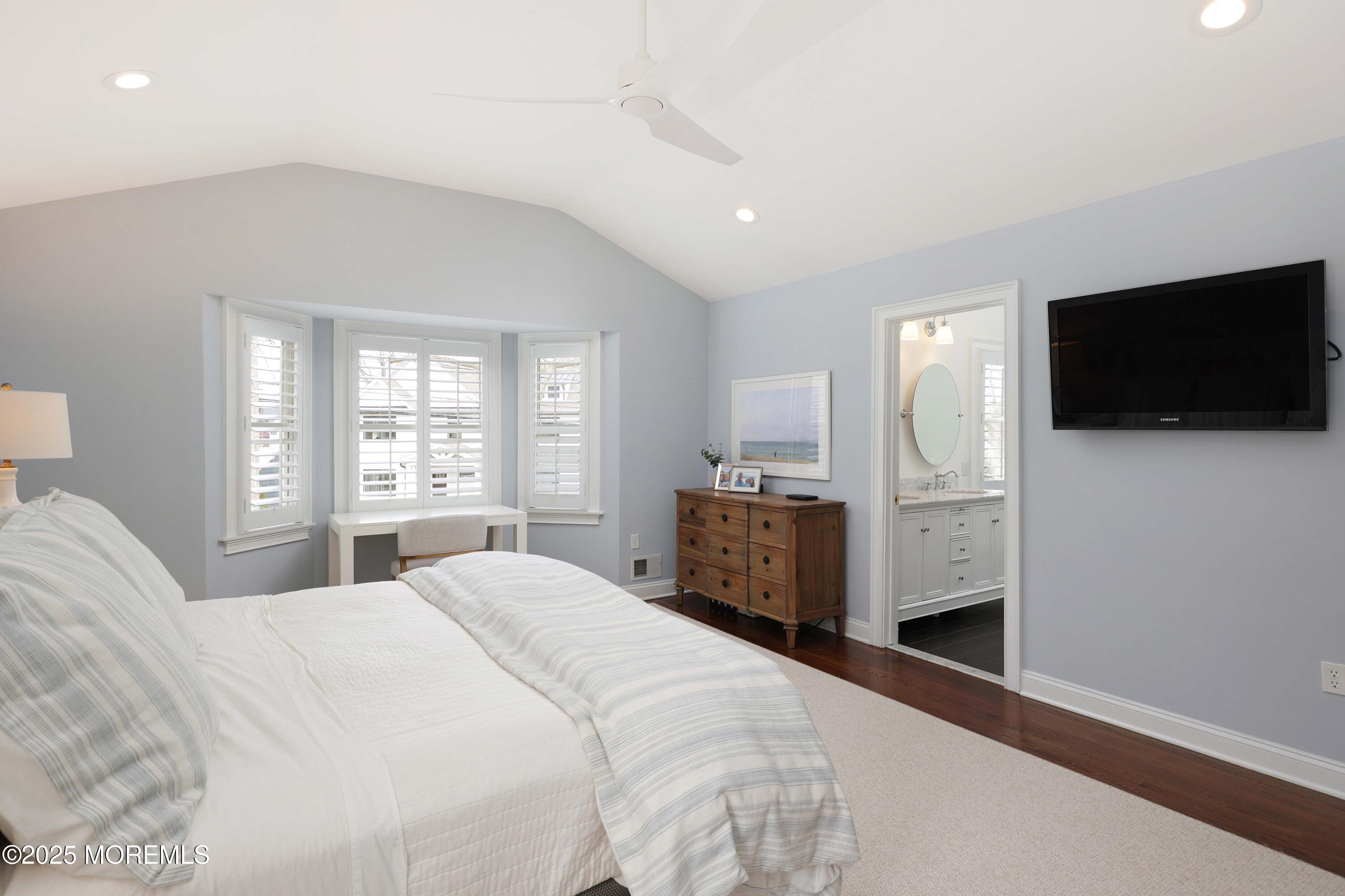 105 Black Point Road Rumson, NJ 07760 - Photo 13 of 27 a large bedroom with a bed and a flat screen tv