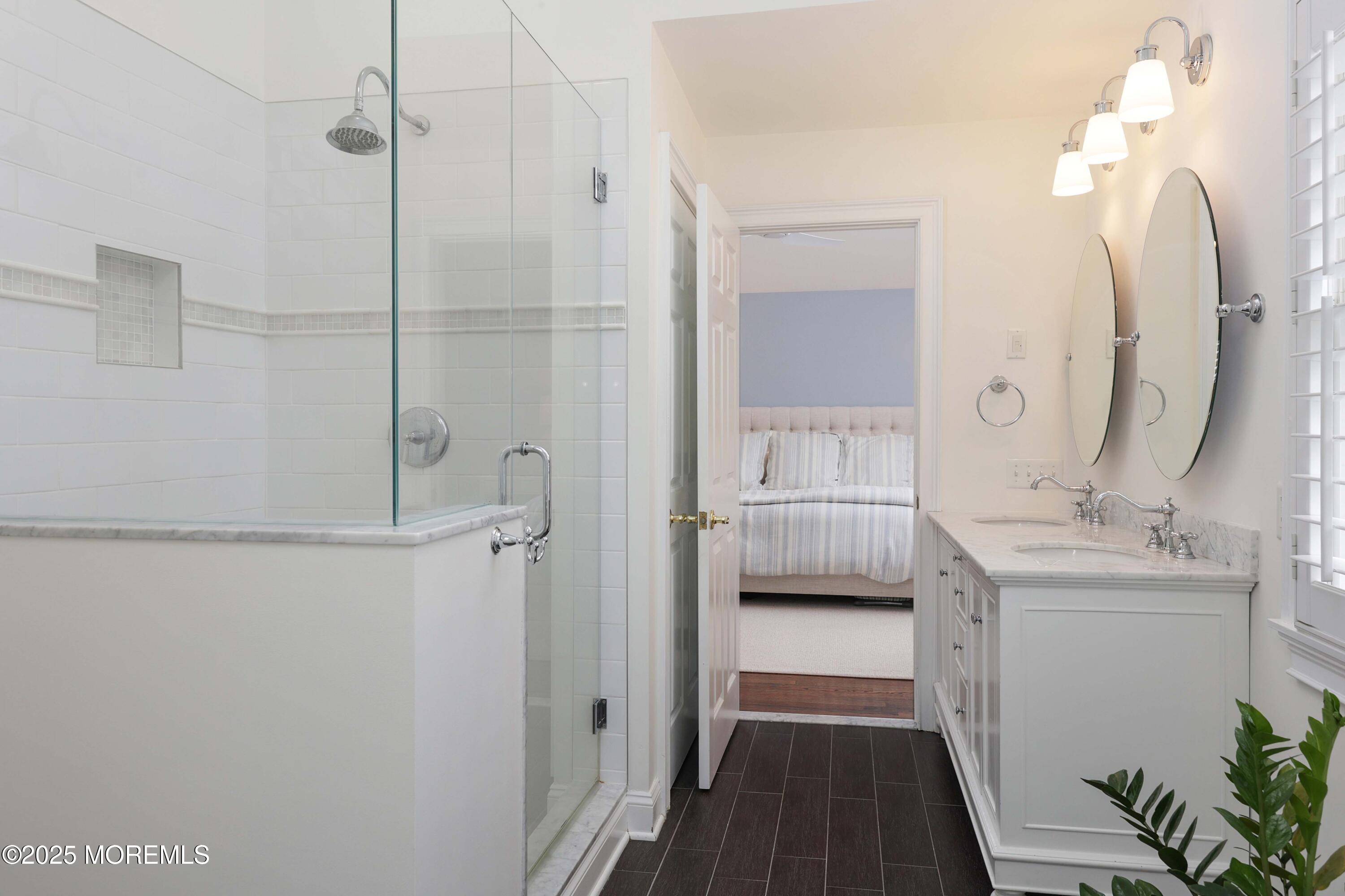 105 Black Point Road Rumson, NJ 07760 - Photo 17 of 27 a bathroom with a double vanity sink a toilet and a mirror