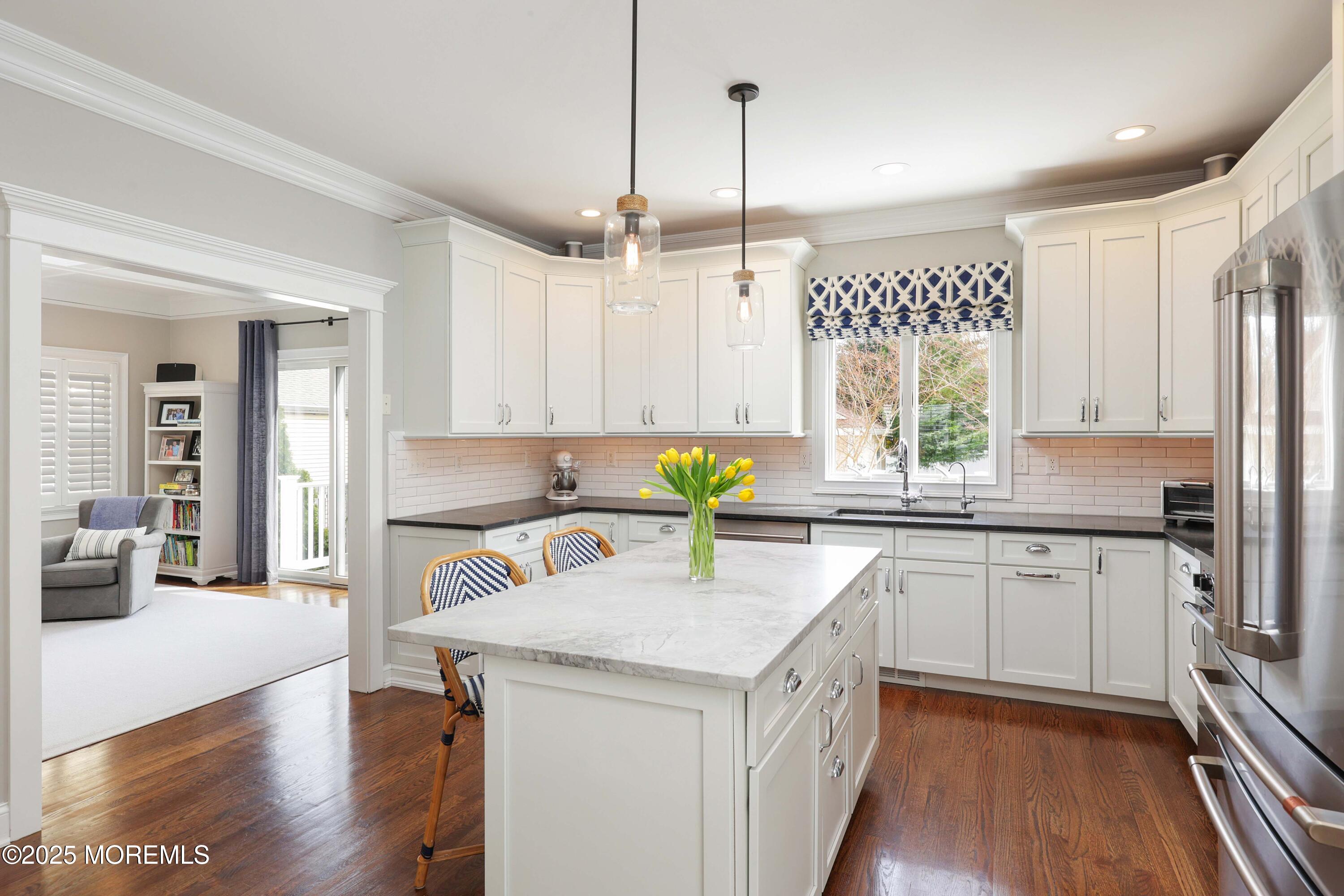 105 Black Point Road Rumson, NJ 07760 - Photo 4 of 27 a kitchen with a sink stove and wooden cabinets