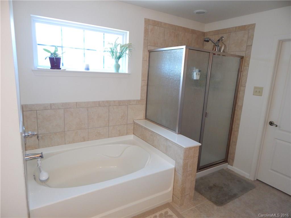 2166 Durand Road, Unit 39 Fort Mill, SC 29715 - Photo 18 of 23 a white bath tub sitting next to a shower
