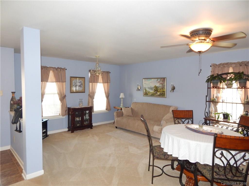 2166 Durand Road, Unit 39 Fort Mill, SC 29715 - Photo 6 of 23 a living room with furniture a fireplace and a chandelier