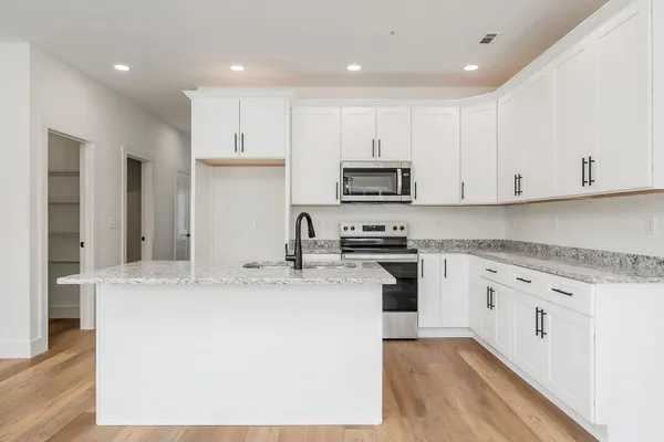 a kitchen with granite countertop a stove and a sink