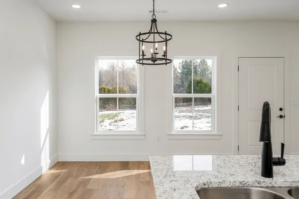 a kitchen that has a sink a stove and window