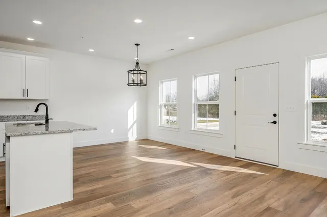 a kitchen with kitchen island a sink stainless steel appliances and cabinets