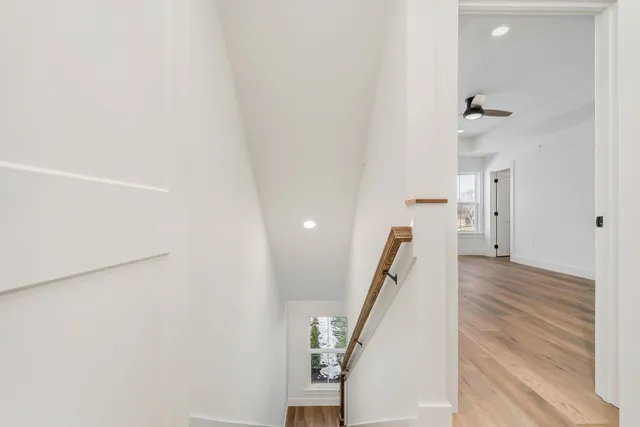 a view of a hallway with wooden floor