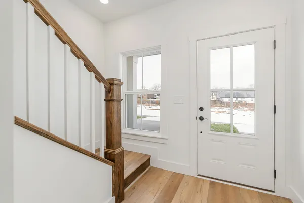 a view of an entryway with wooden floor