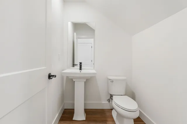a bathroom with a sink toilet and a mirror