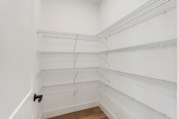 a kitchen with kitchen island white cabinets and stainless steel appliances