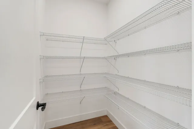 a kitchen with kitchen island white cabinets and stainless steel appliances