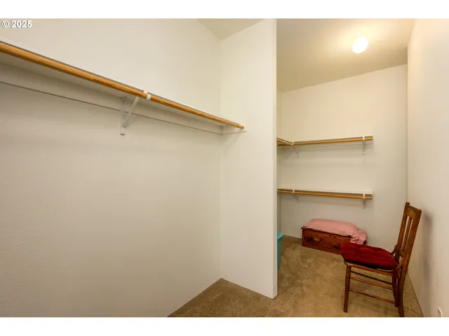 a view of a room with furniture and a window