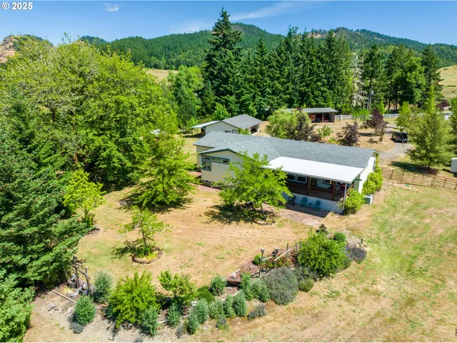 an aerial view of a house with a yard