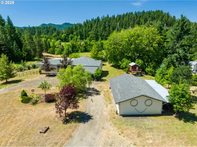 an aerial view of a house with garden space and street view