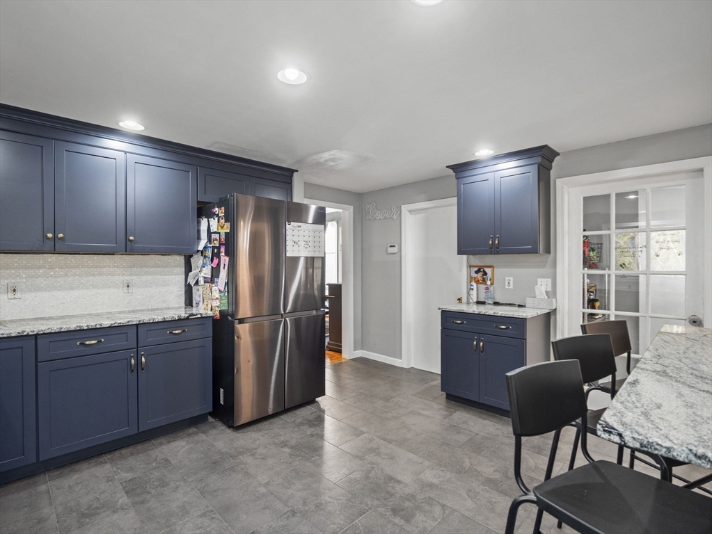 49 County Road Marion, MA 02738 - Photo 5 of 34 a kitchen with stainless steel appliances kitchen island granite countertop a refrigerator stove and sink